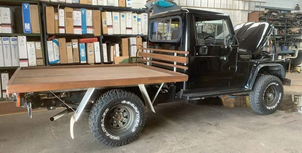 A Black Truck With a Wooden Bed is Parked in a Garage — Neilsen's Radiator Service in Dalby, QLD