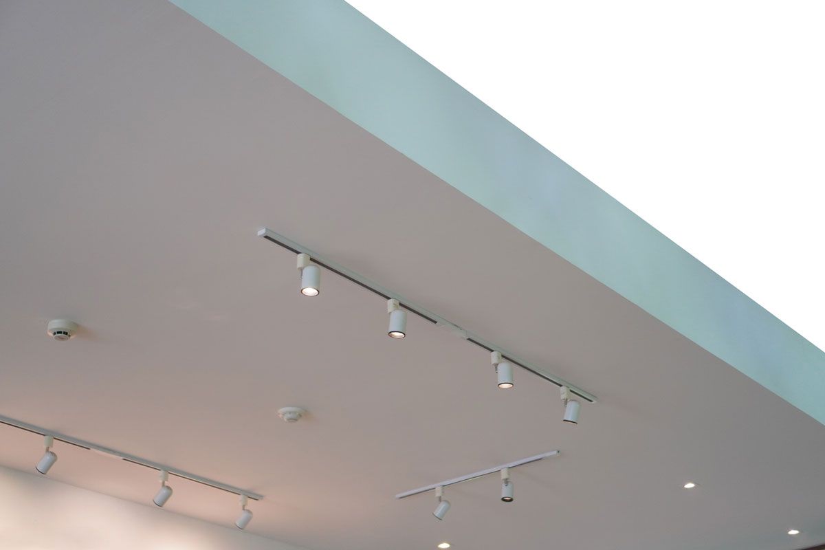 White ceiling with track lighting fixtures.