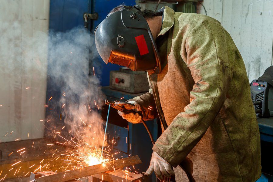 man welds the metal