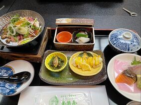 A table topped with plates of food and bowls of food.