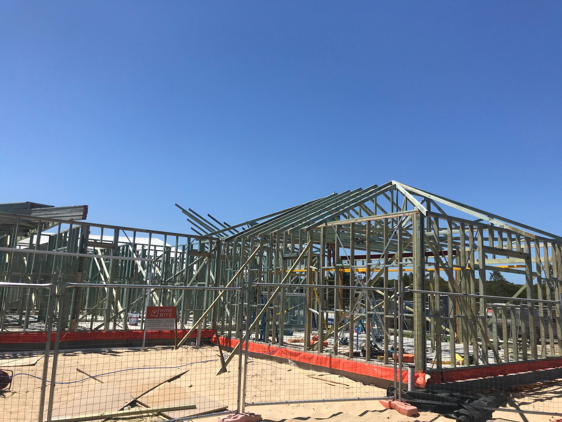 Steel Frame of a House Under Construction Against a Clear Blue Sky — Keystone Property Solutions In Waratah, NSW