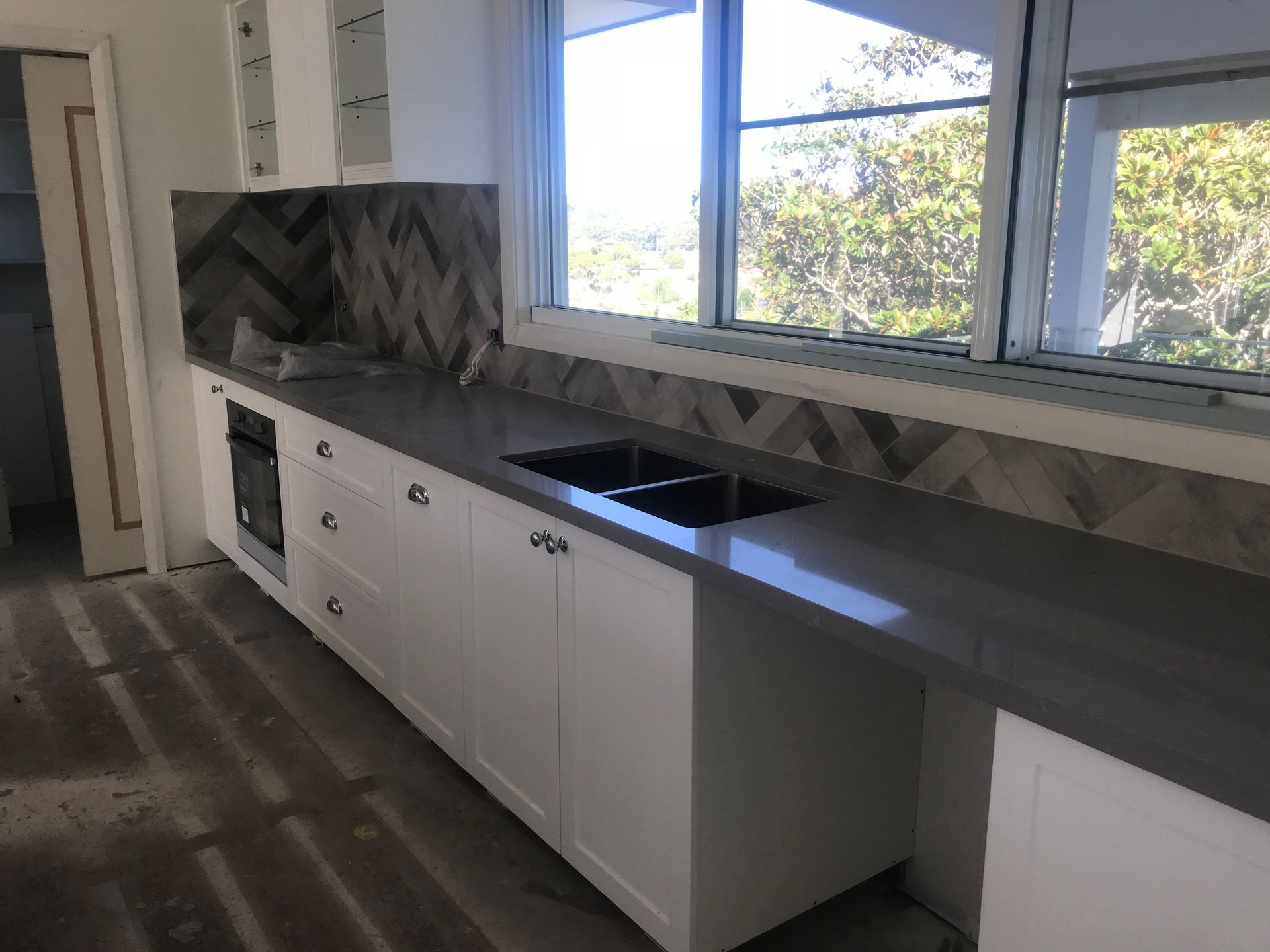 Person in Protective Suit Using a Moisture Meter on Moldy Wall — Keystone Property Solutions In Waratah, NSW