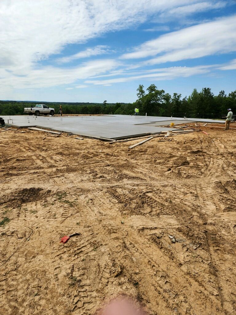 A person is standing in the middle of a dirt field.