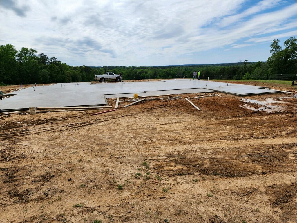 A truck is parked in the middle of a dirt field.