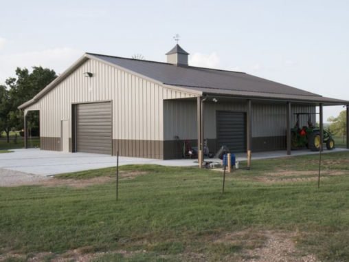 A large metal building with a tractor parked in front of it