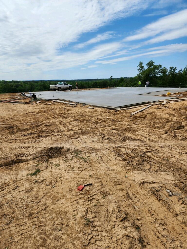 A truck is parked in the middle of a dirt field.