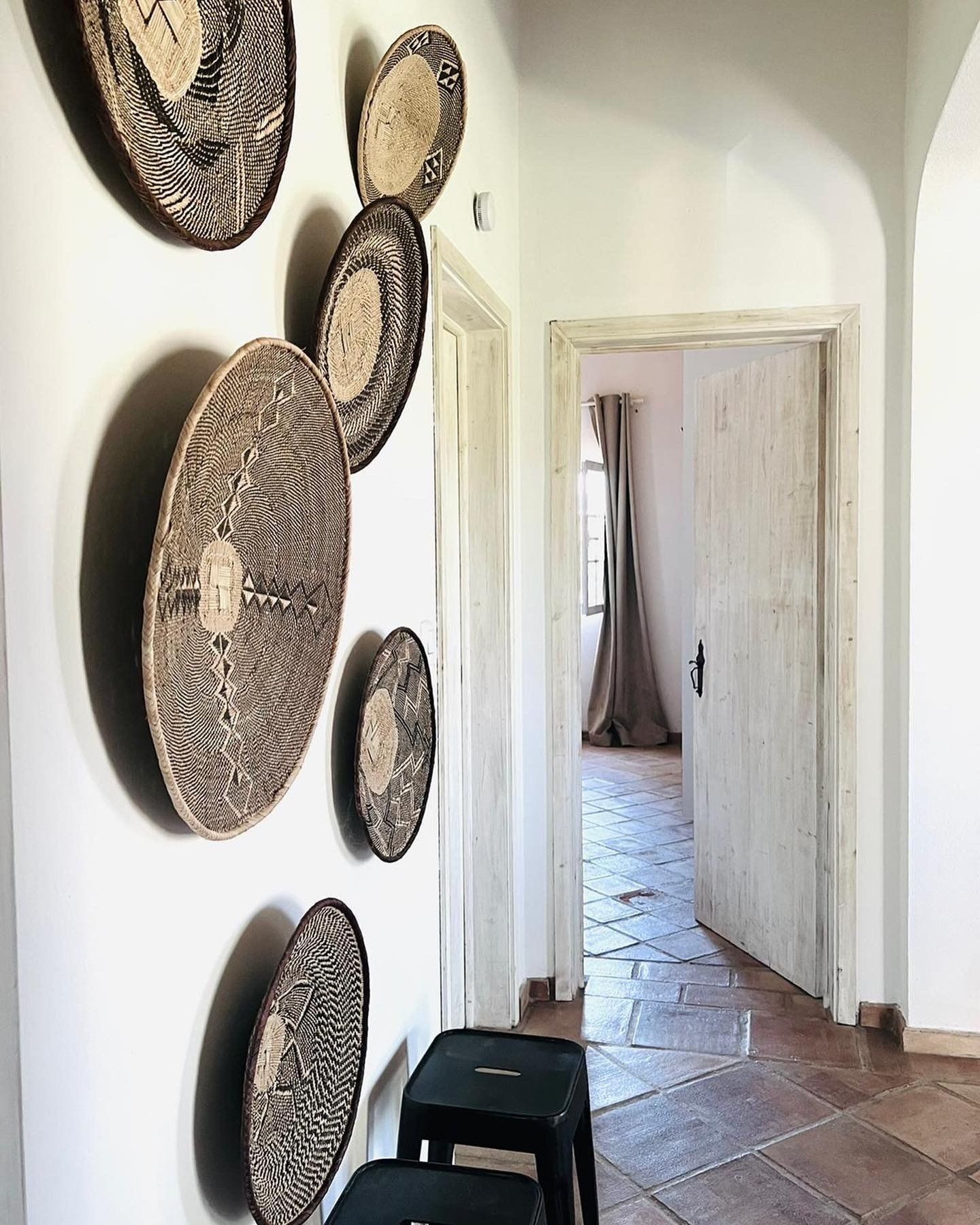 A hallway with a bunch of baskets on the wall