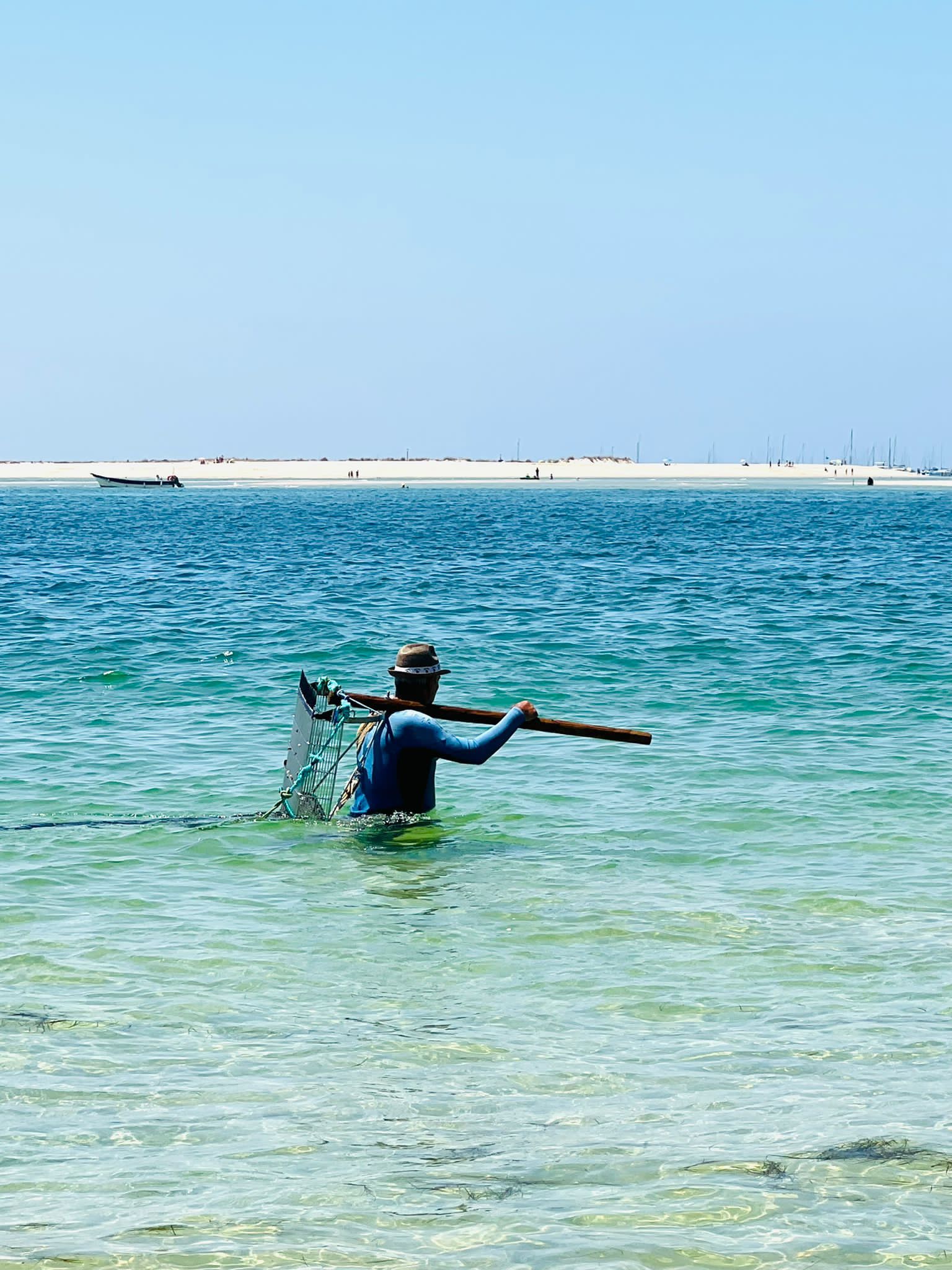 Een man vist in de oceaan met een net