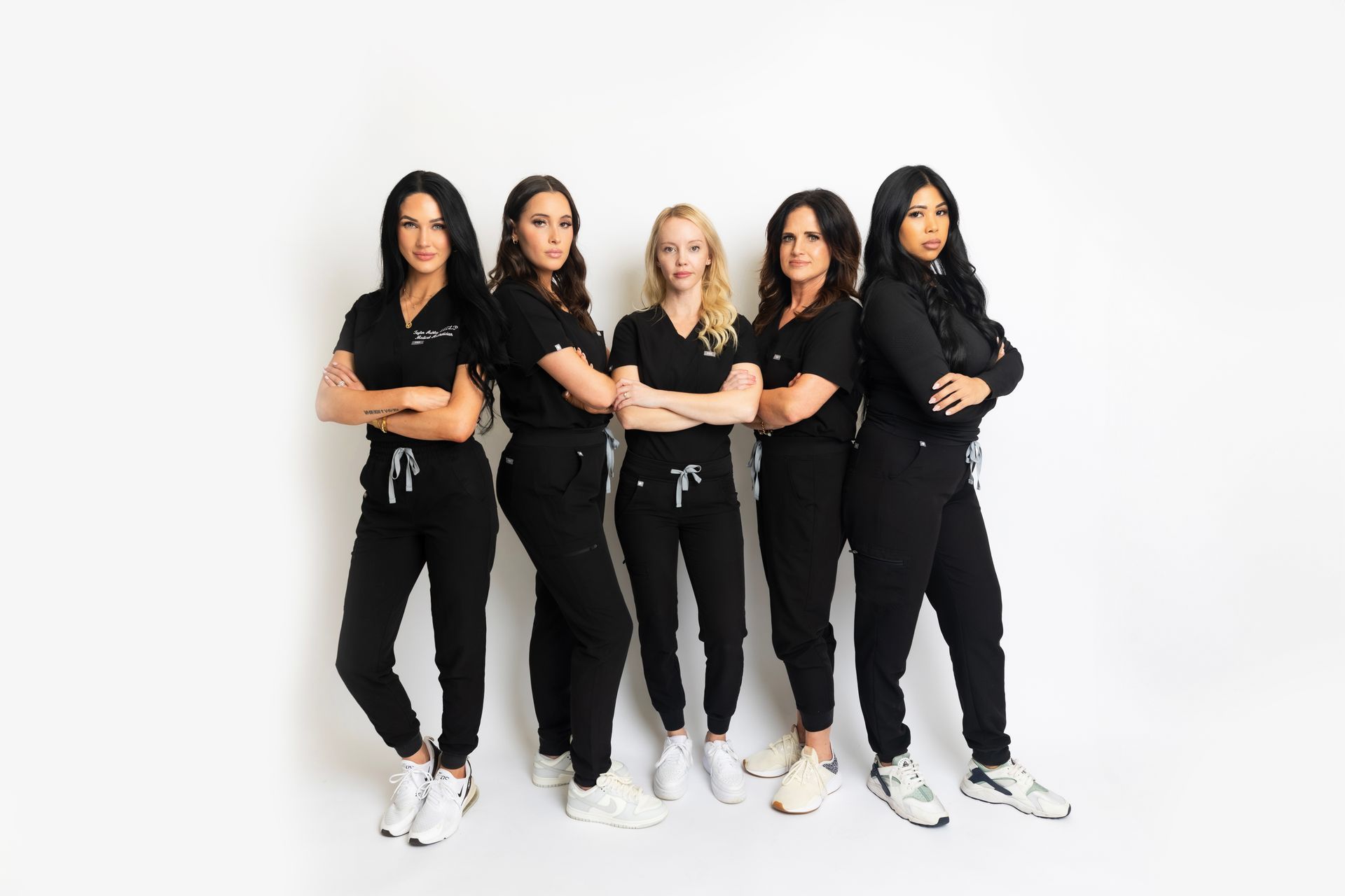 A group of women are posing for a picture together.