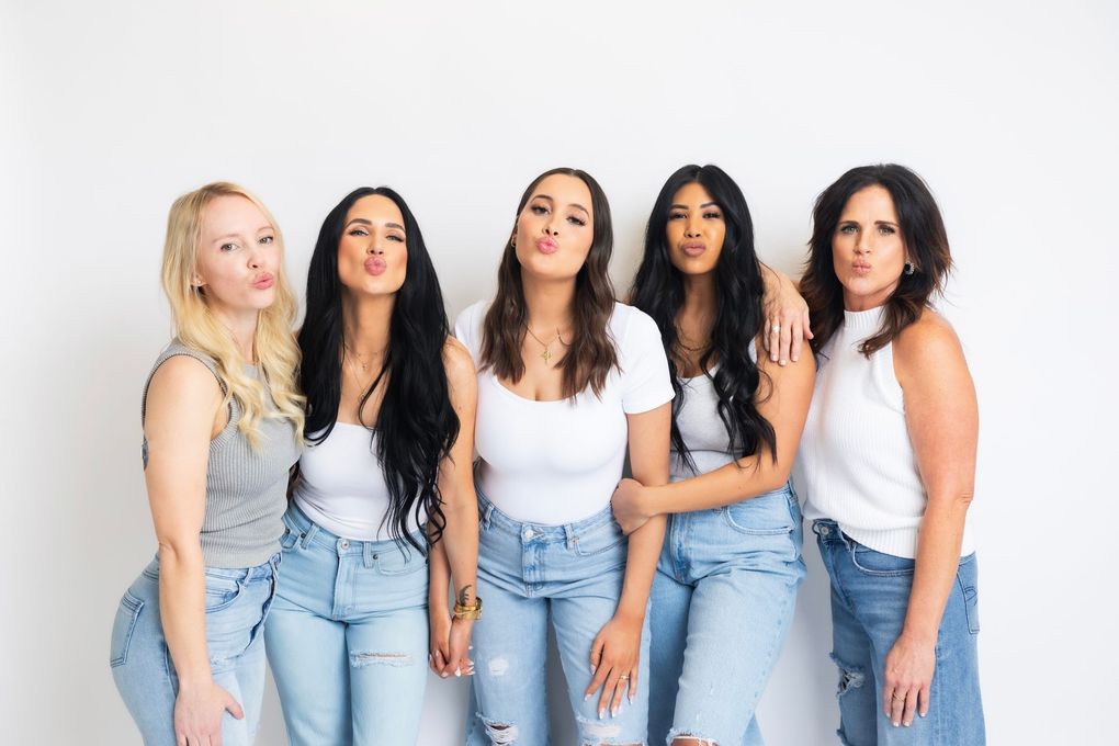 A group of women are posing for a picture together.