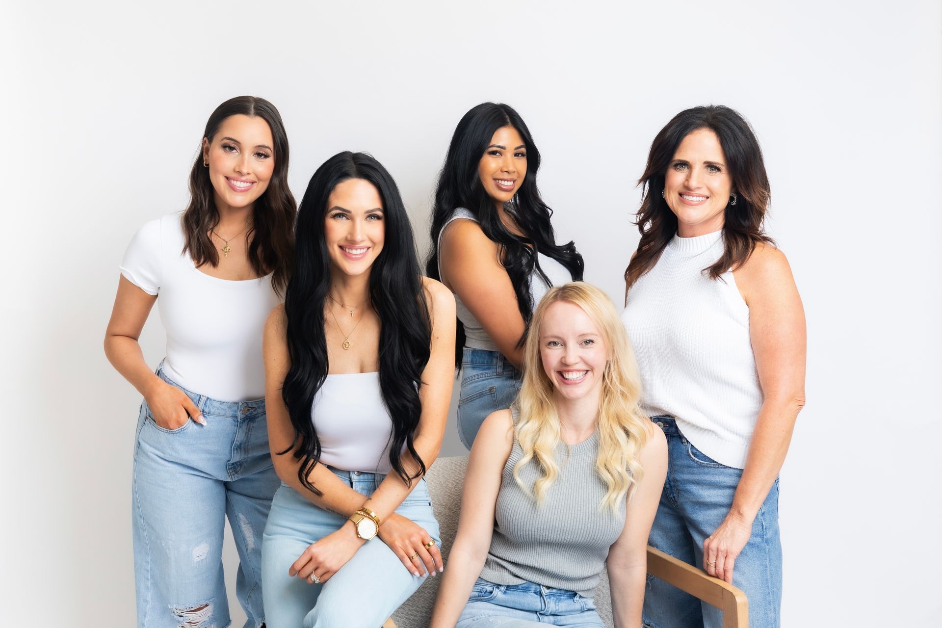 A group of women are posing for a picture together.