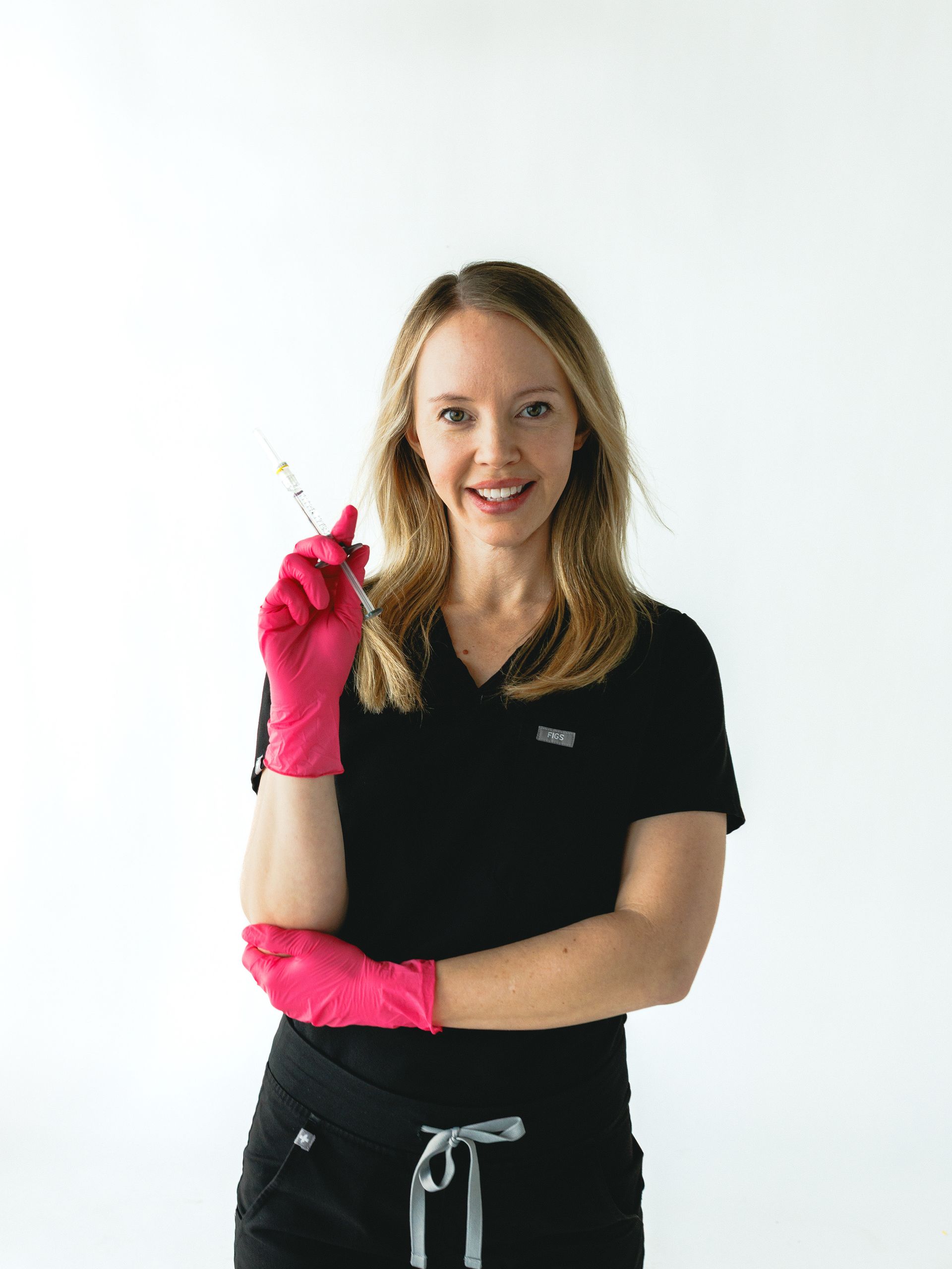 A group of women in black scrubs are posing for a picture.
