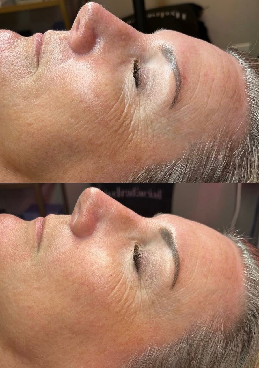 A woman is smiling and touching her face with her hands.