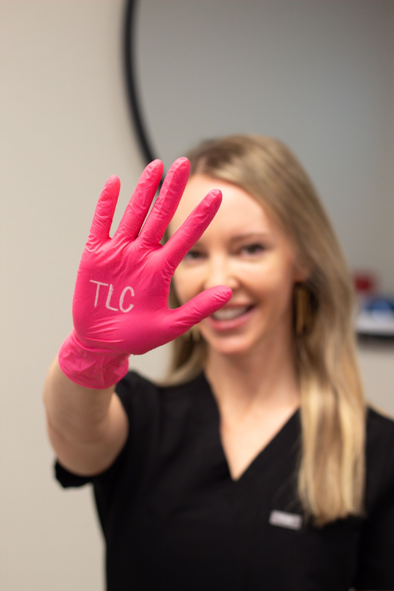 A group of women in black scrubs are posing for a picture.