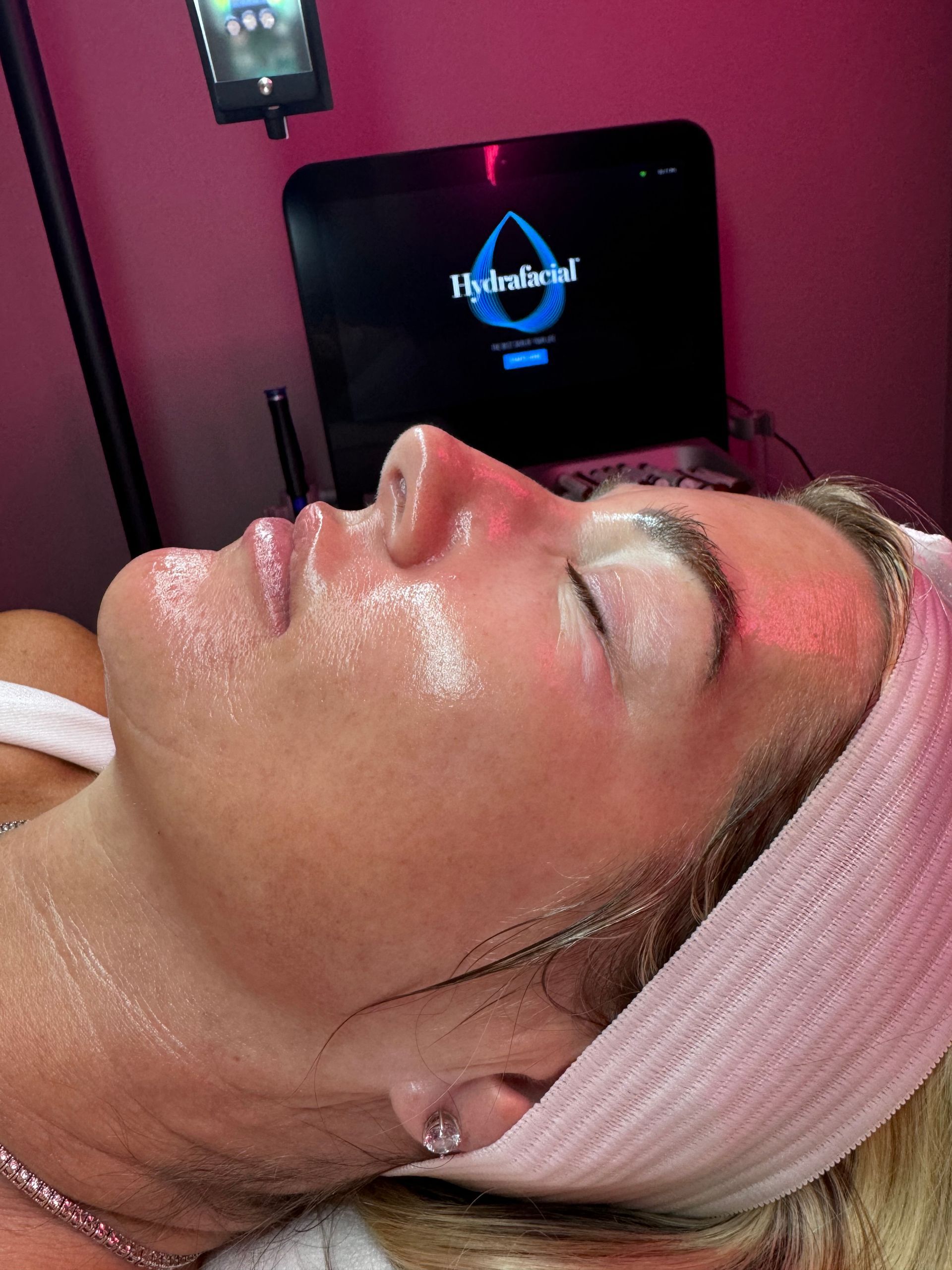 A woman is laying on a bed with a headband on her head.