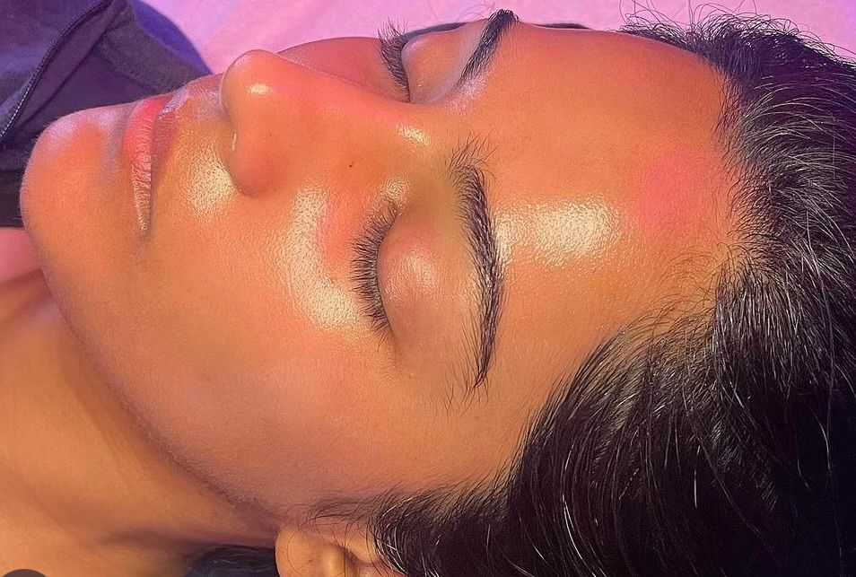 A close up of a woman 's face with her eyes closed.