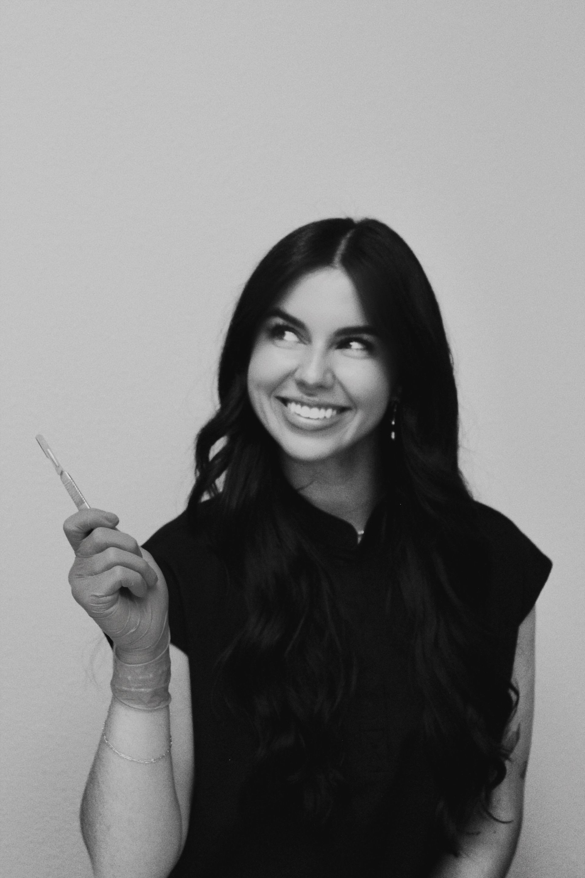 A woman is laying on a bed with steam coming out of her face.