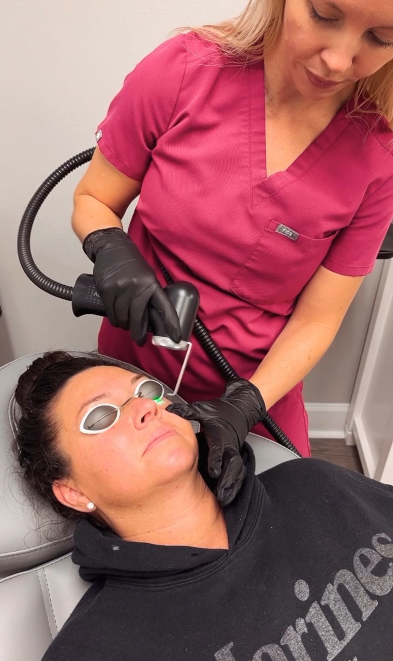 A woman is getting a botox injection in her face.
