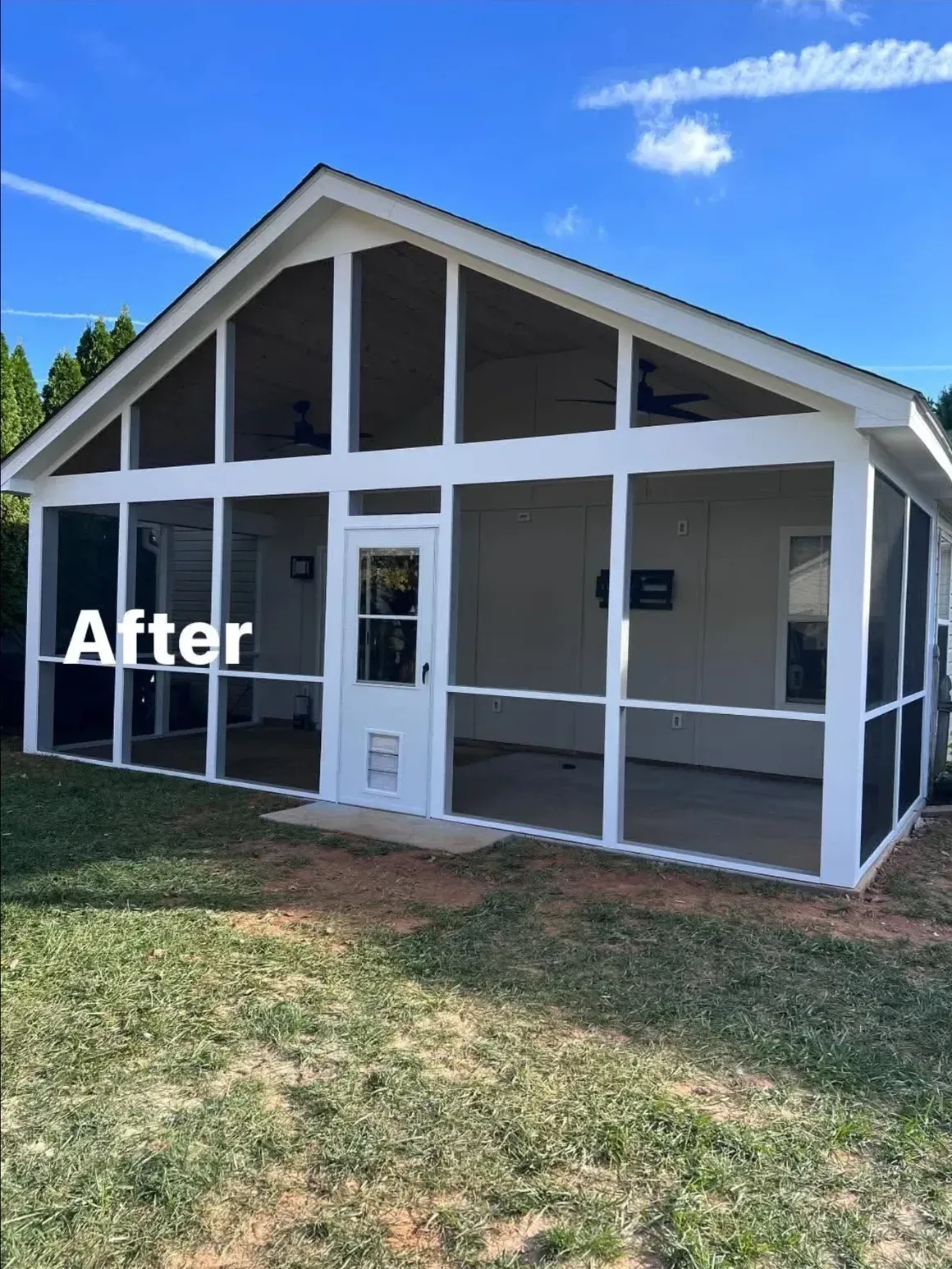 A white-framed screened-in porch with a central door and ceiling fans, set against a bright blue sky.