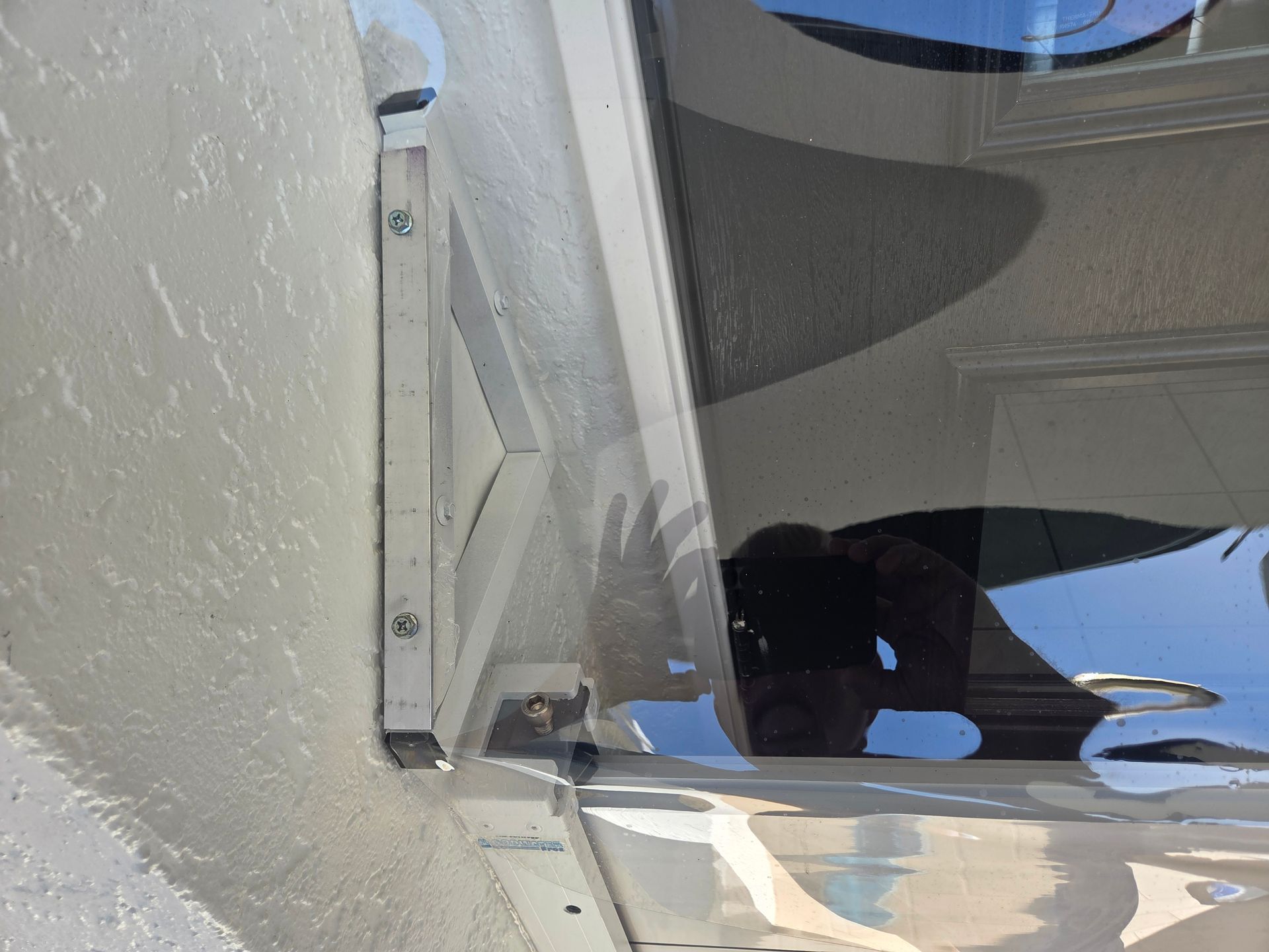 Metal RV stairwell with an air vent attached to the wall.