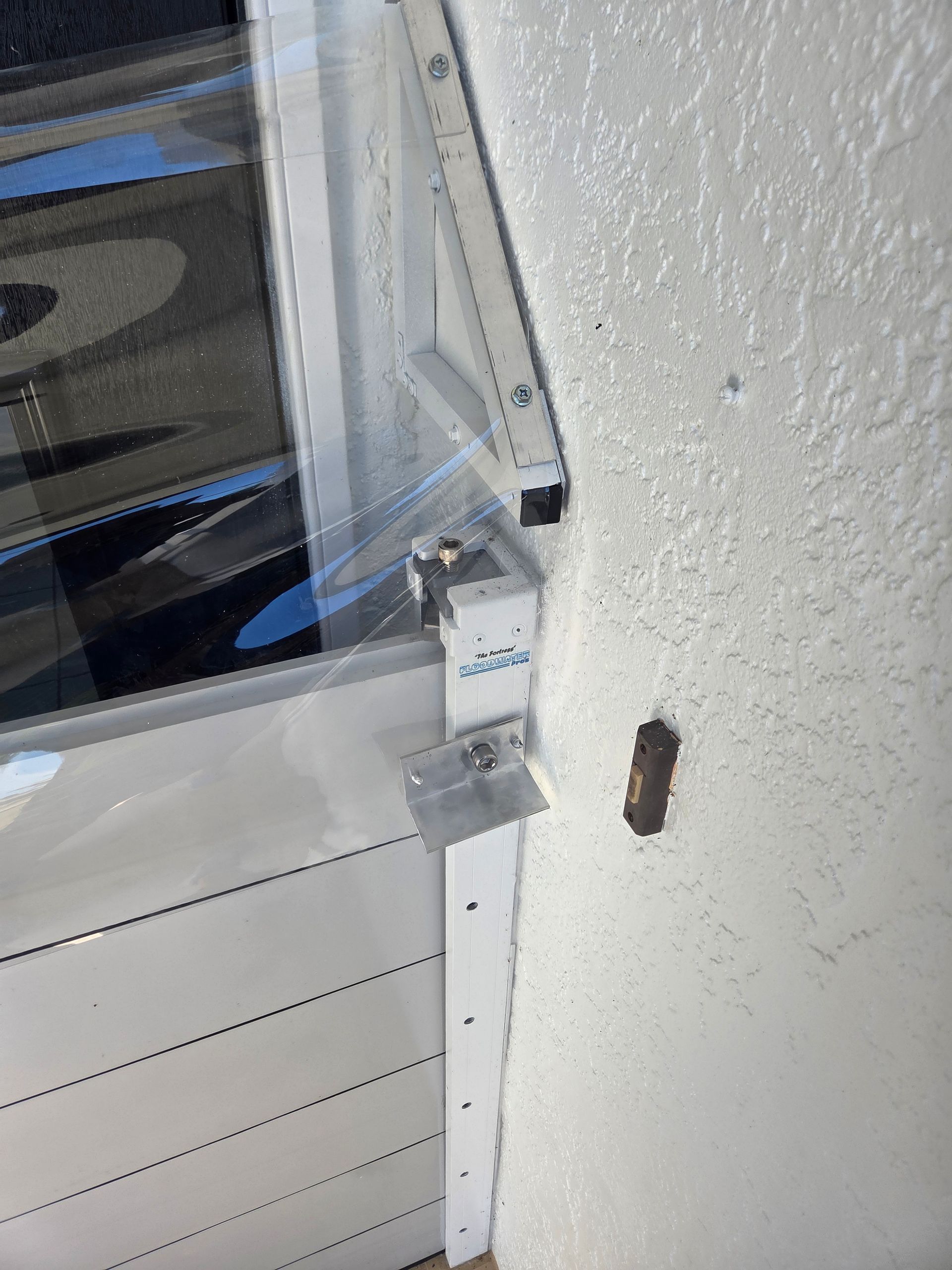 Metal framed window with a clear covering mounted to a white wall.