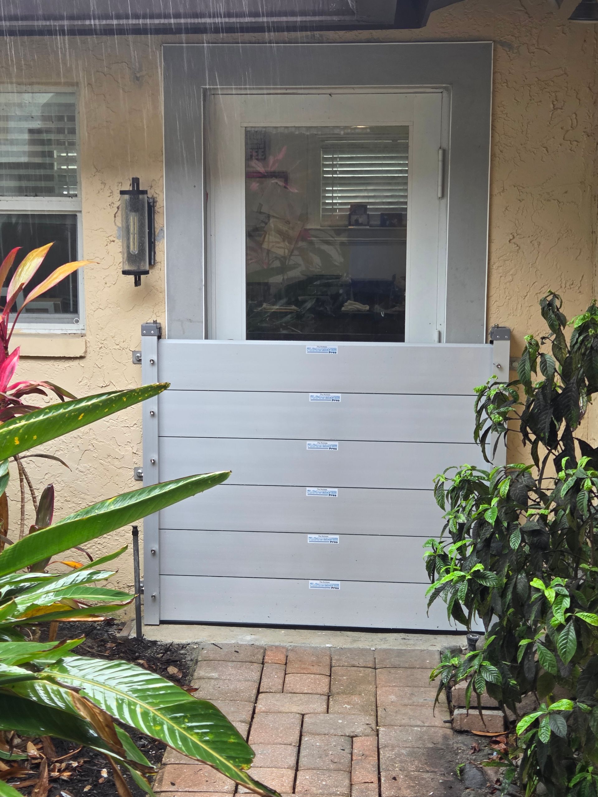 The front door of a house with a flood barrier on it.