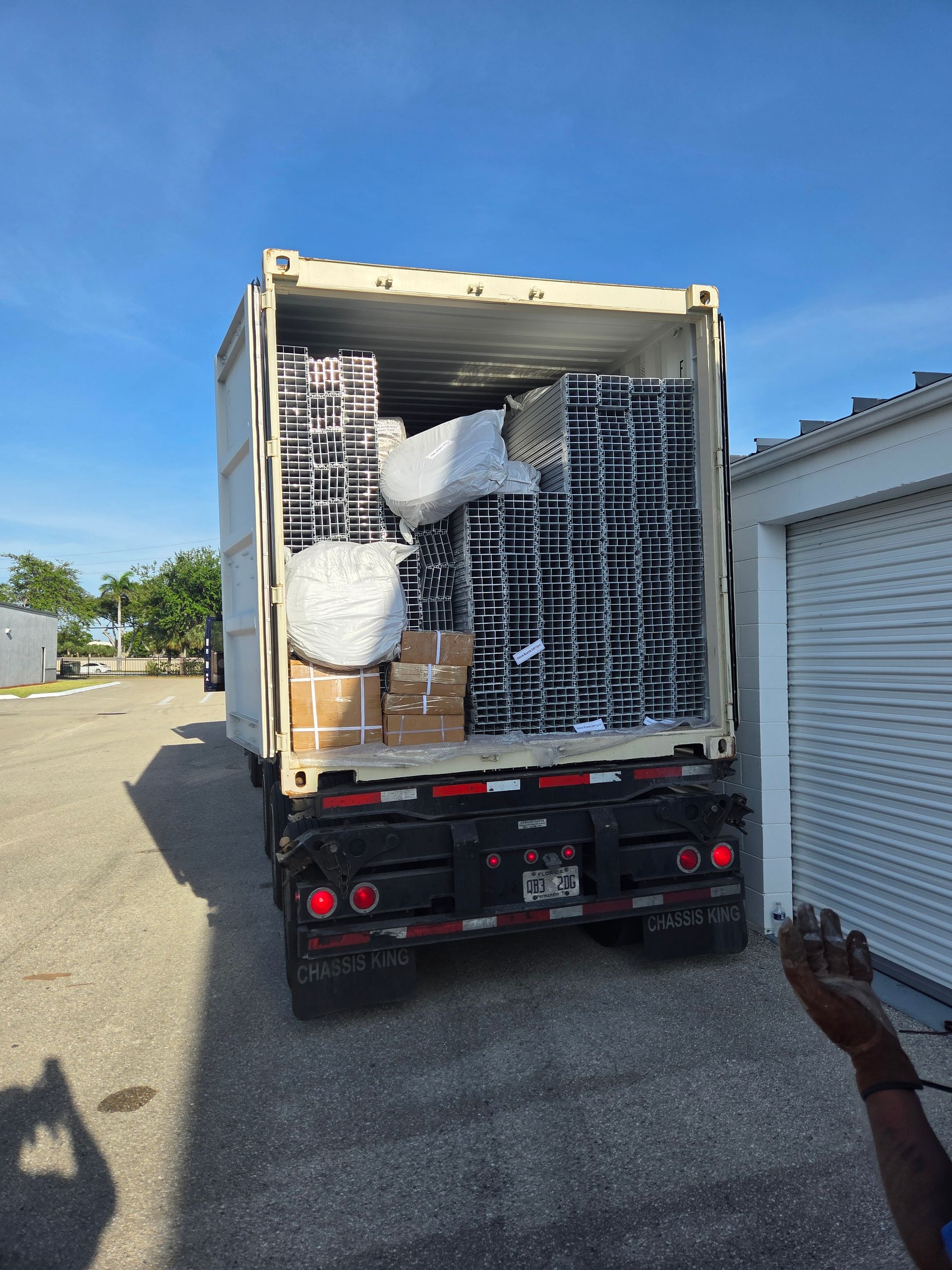 A large container truck is filled with boxes and bags.