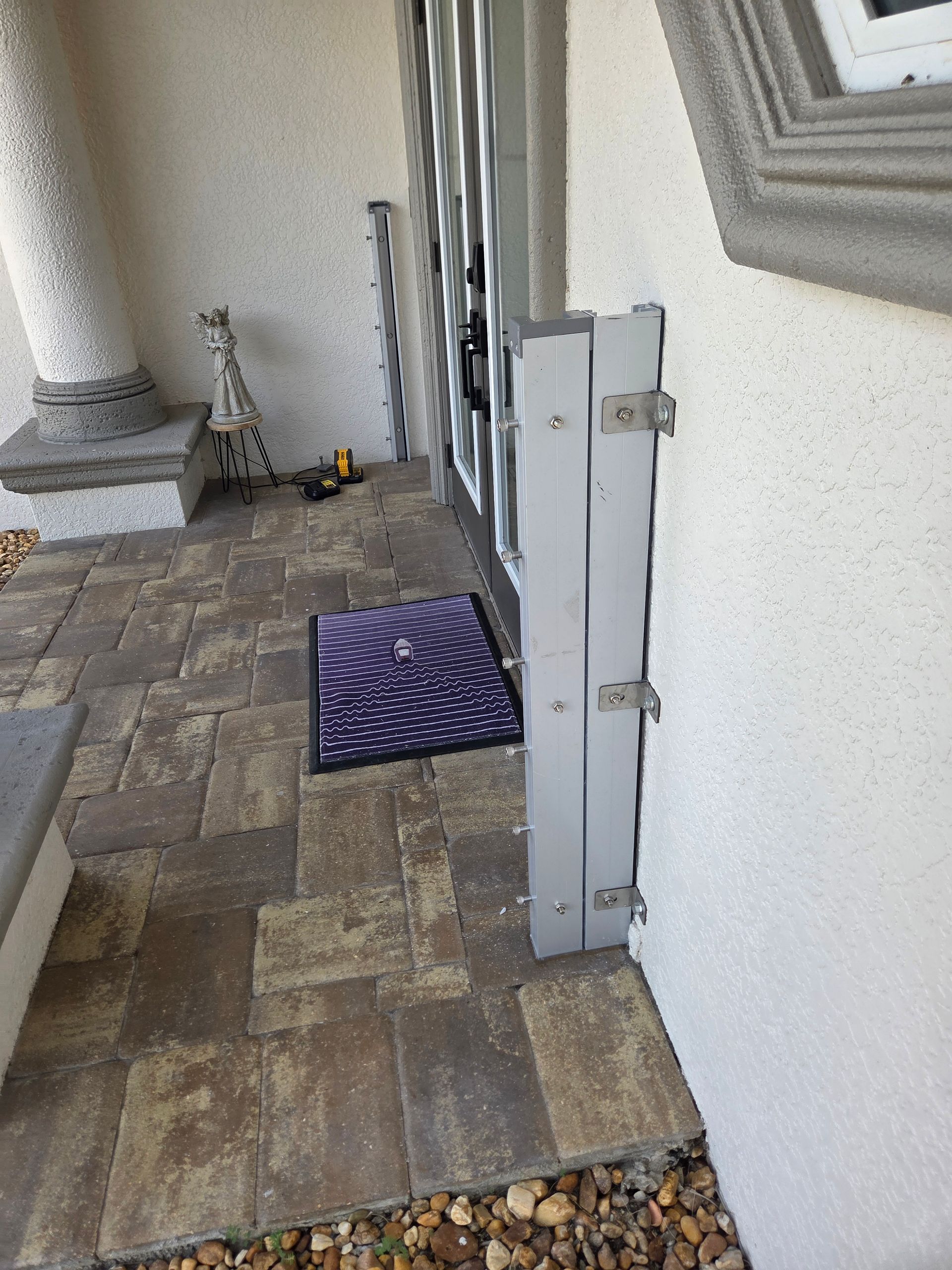 A door with a gate and a door mat on the side of it.