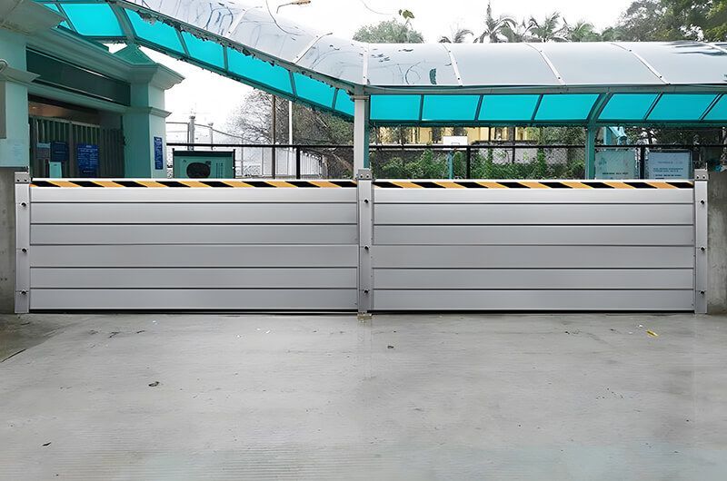 A building with a blue roof and a few barriers in front of it