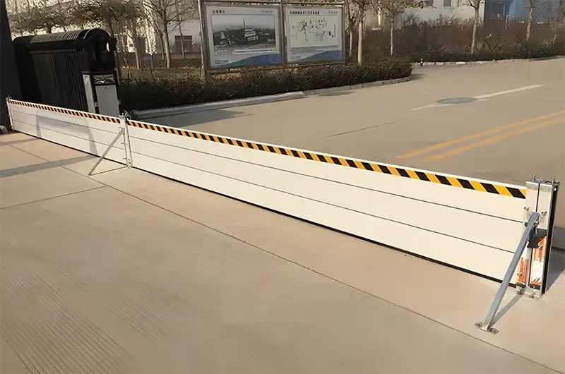 A large white barrier is sitting on the side of a road.