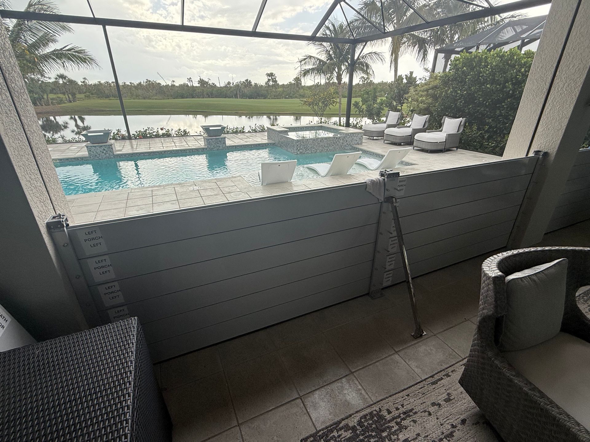 A balcony with a view of a swimming pool.