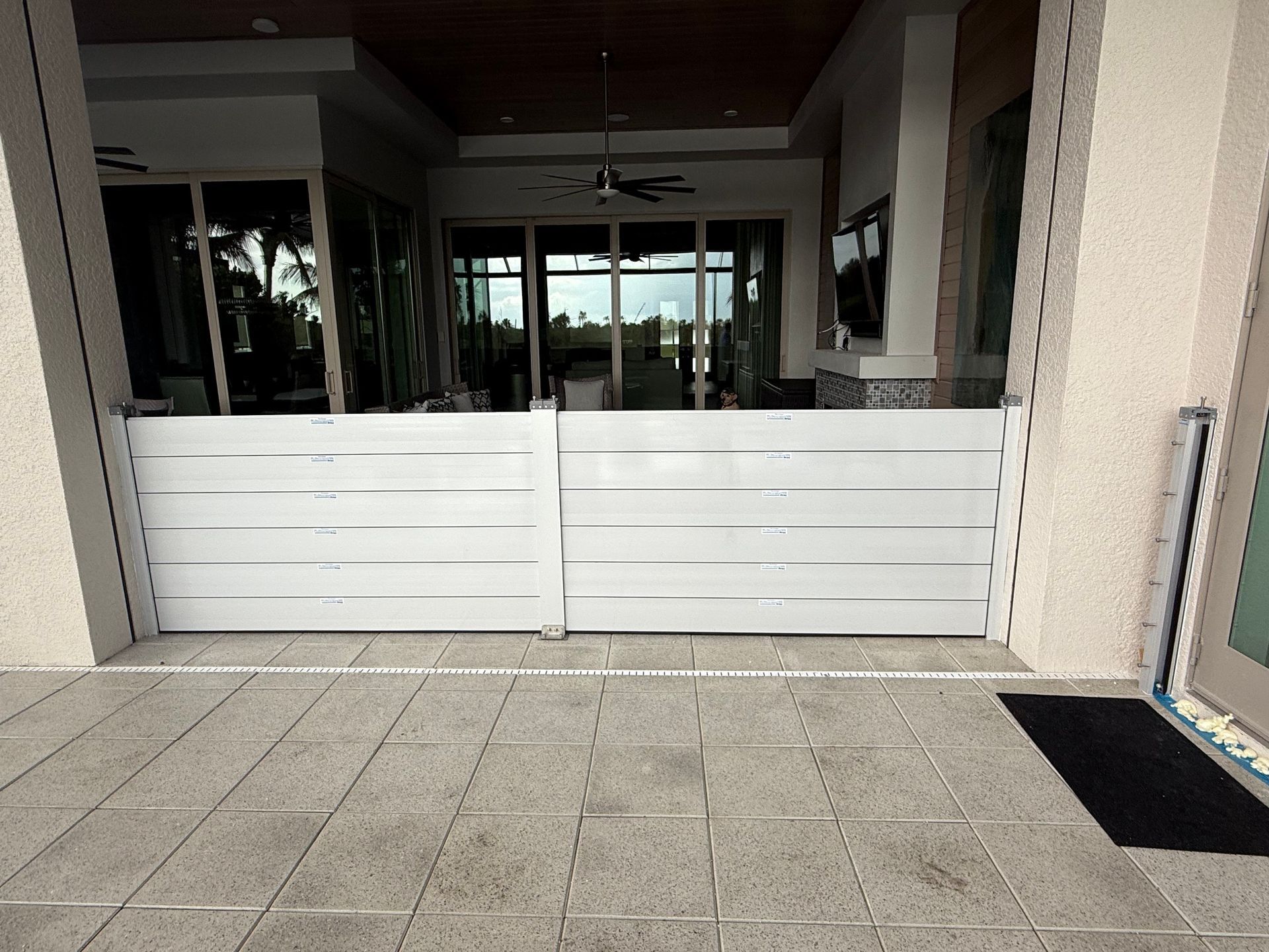 A white flood barrier is sitting on the sidewalk in front of a building.