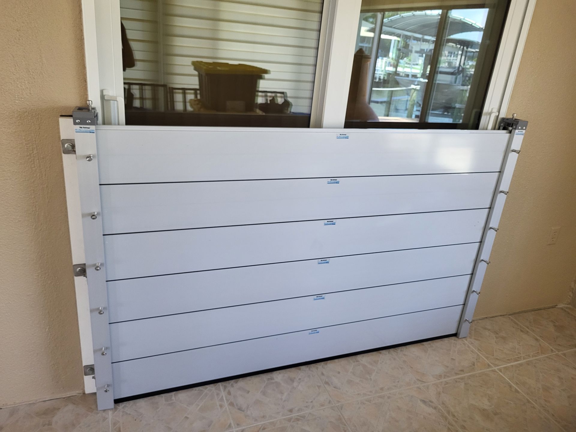 A white door with a flood barrier attached to it