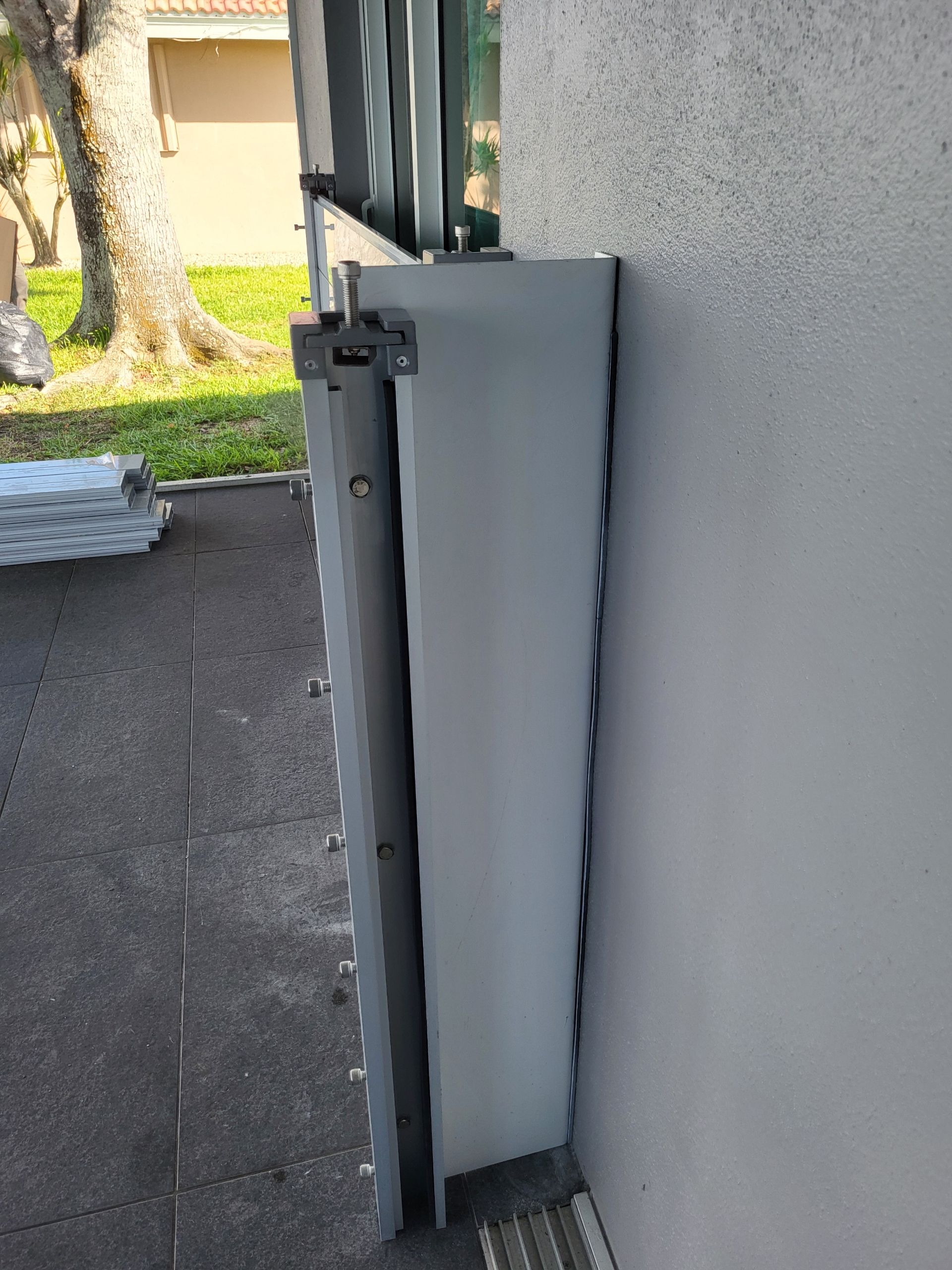 A white fence is sitting on the side of a building.