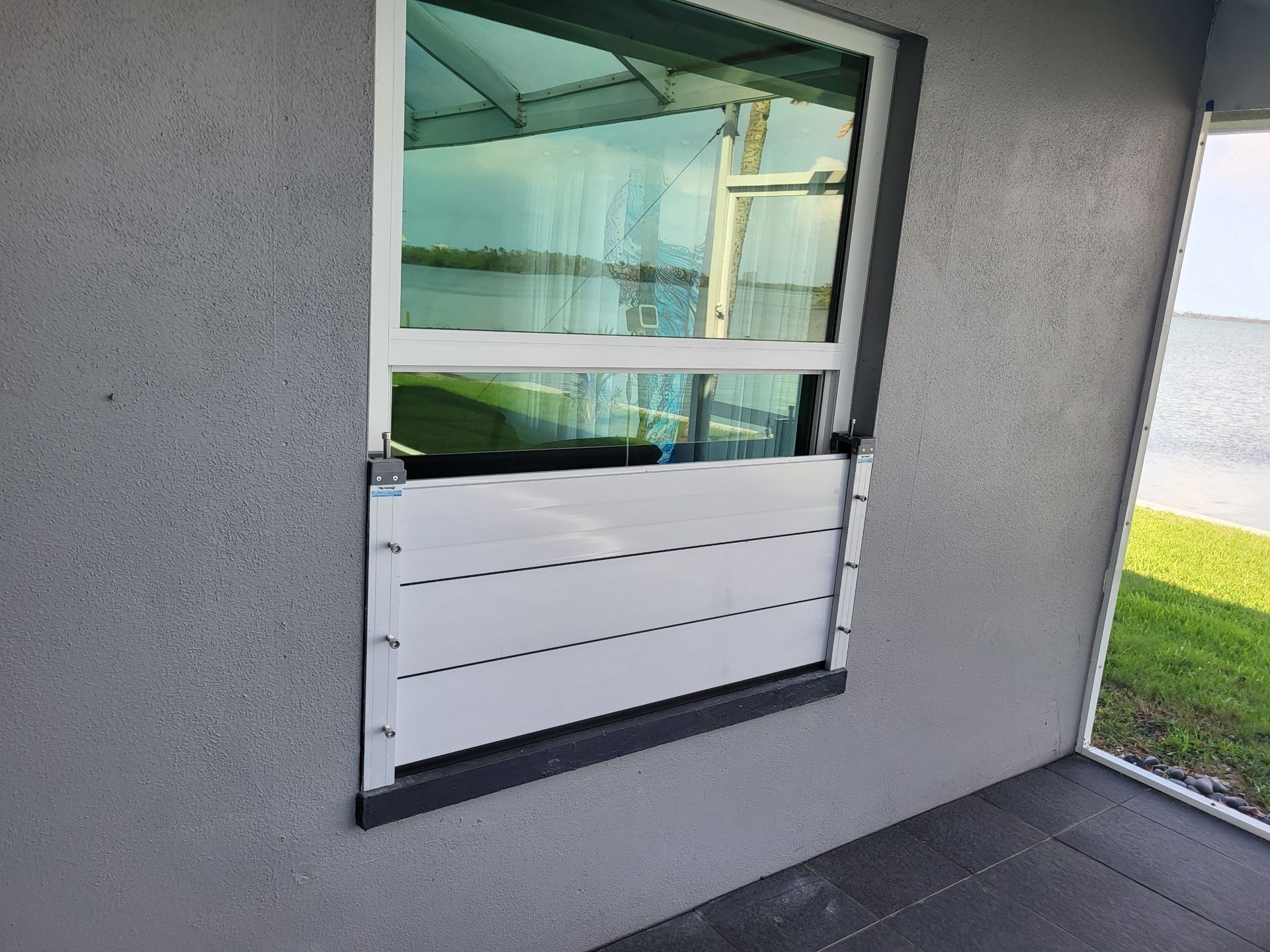 A window with a flood barrier attached to it.