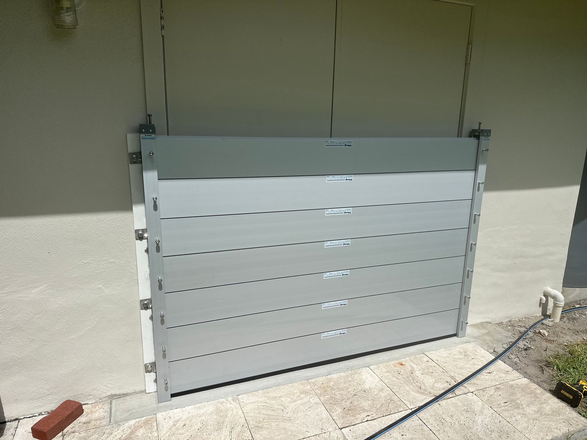 A flood barrier is sitting on the side of a building