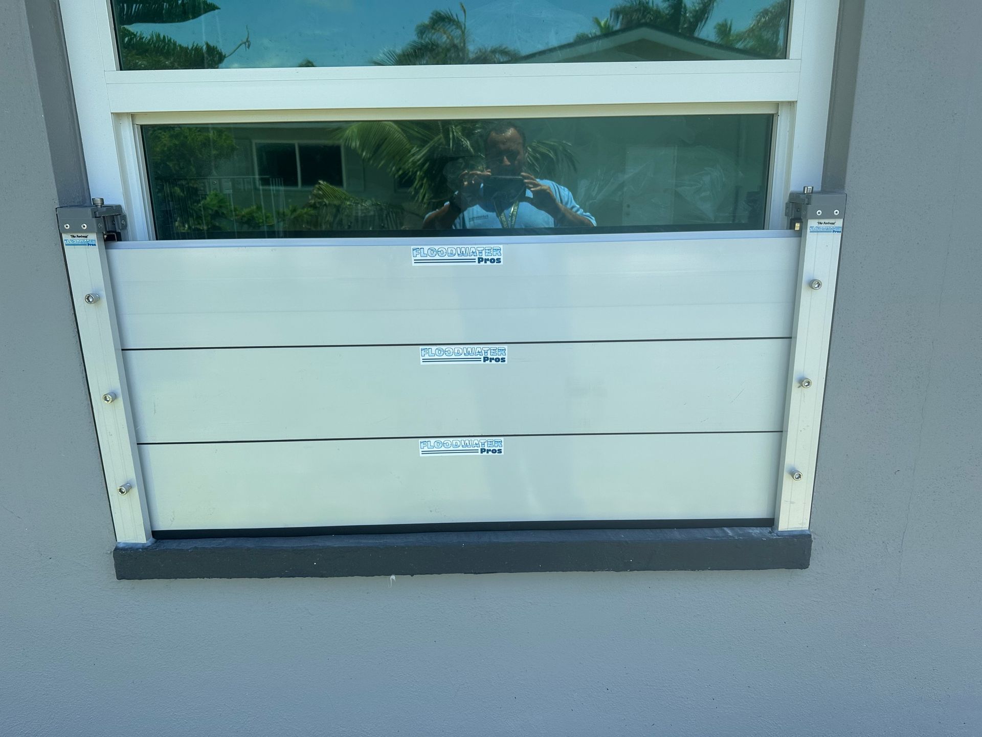 A window with a flood barrier attached to it