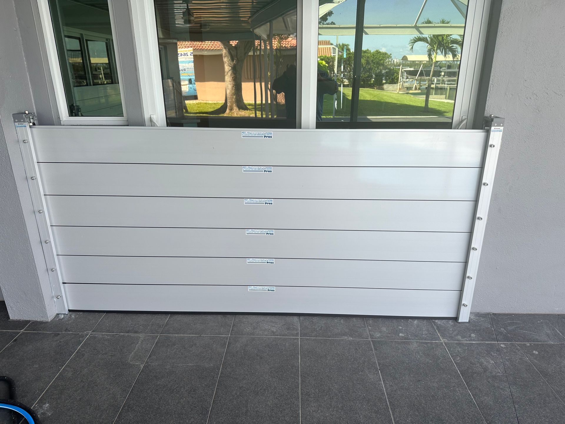 A white flood barrier is sitting in front of a window.