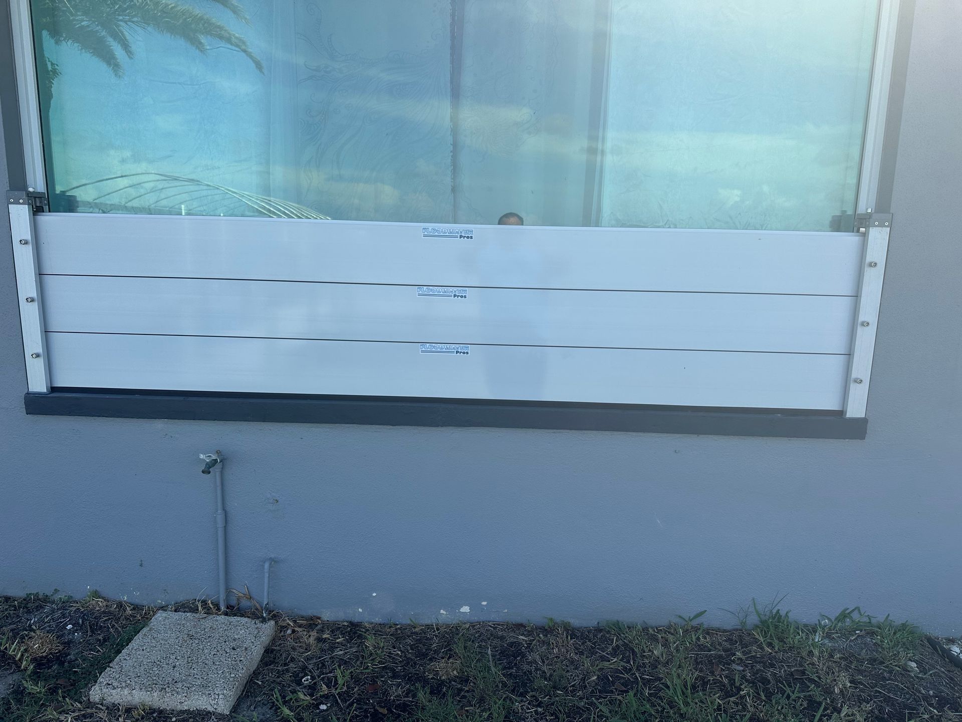 A window with a flood barrier attached to it.