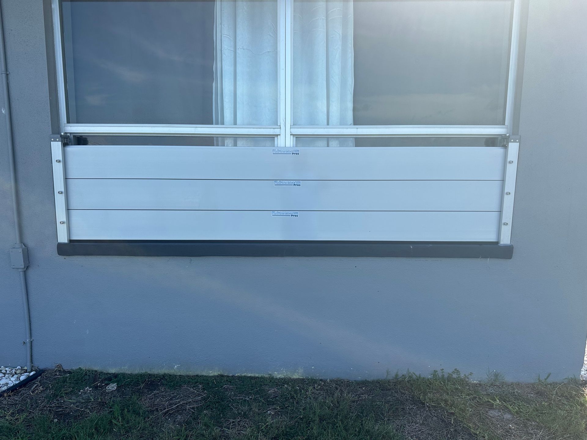 A window with a flood barrier attached to it.