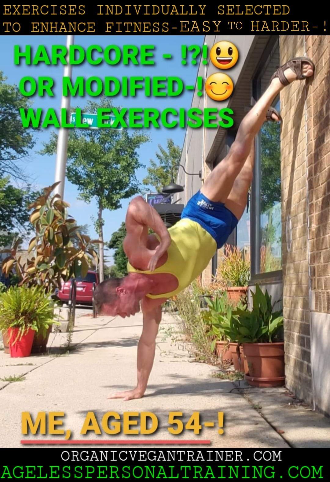 A man is doing a handstand on a sidewalk in front of a building