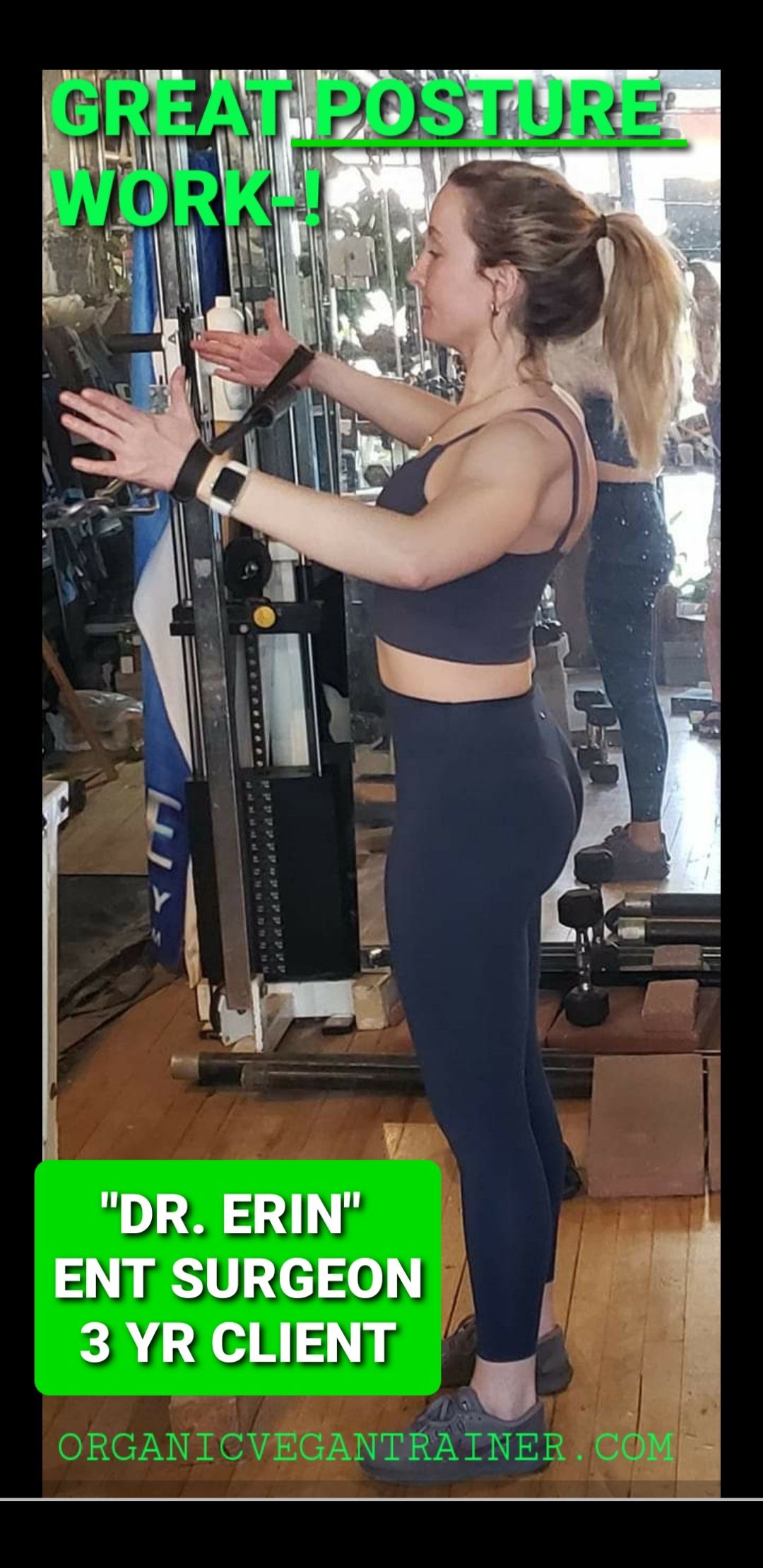 A woman is standing in a gym with her arms outstretched.