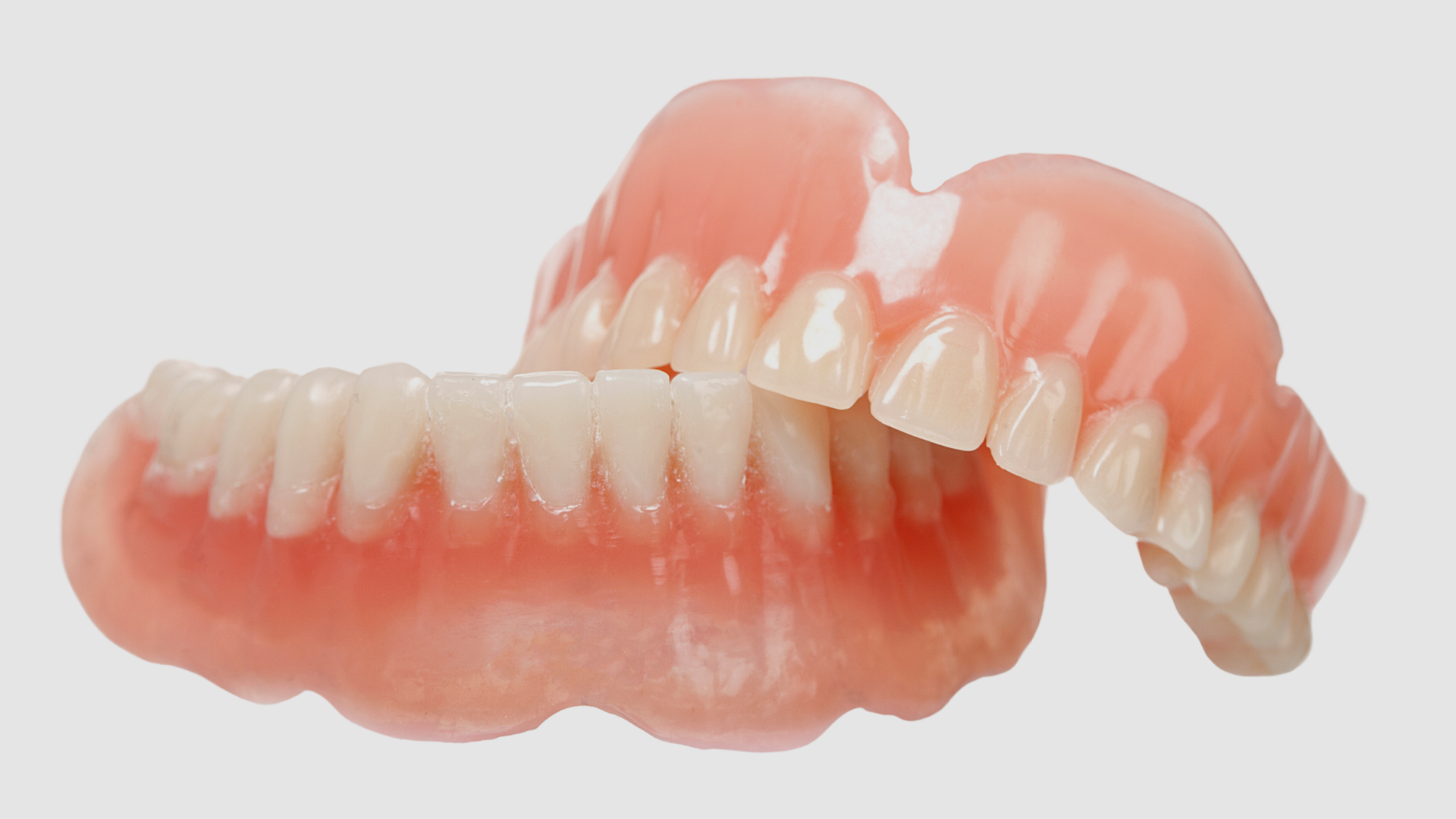A close up of a pair of dentures on a white background.