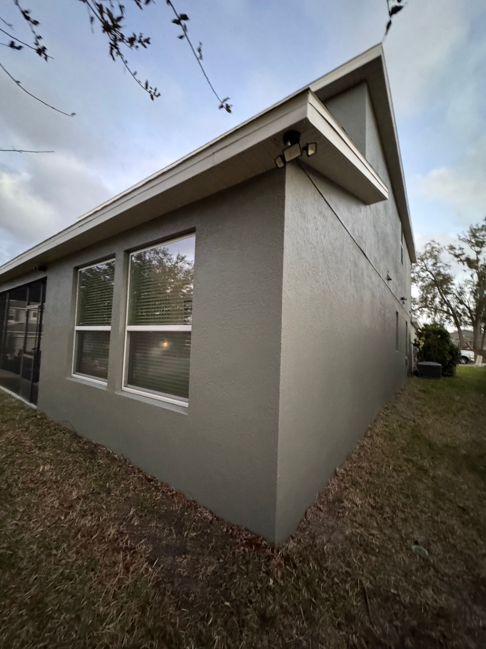 Dark brown double French doors with glass panes and closed white internal blinds.