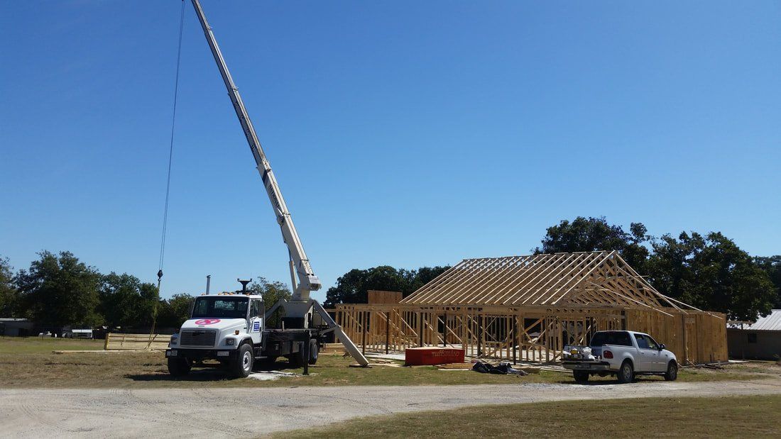 A crane is being used to build a house