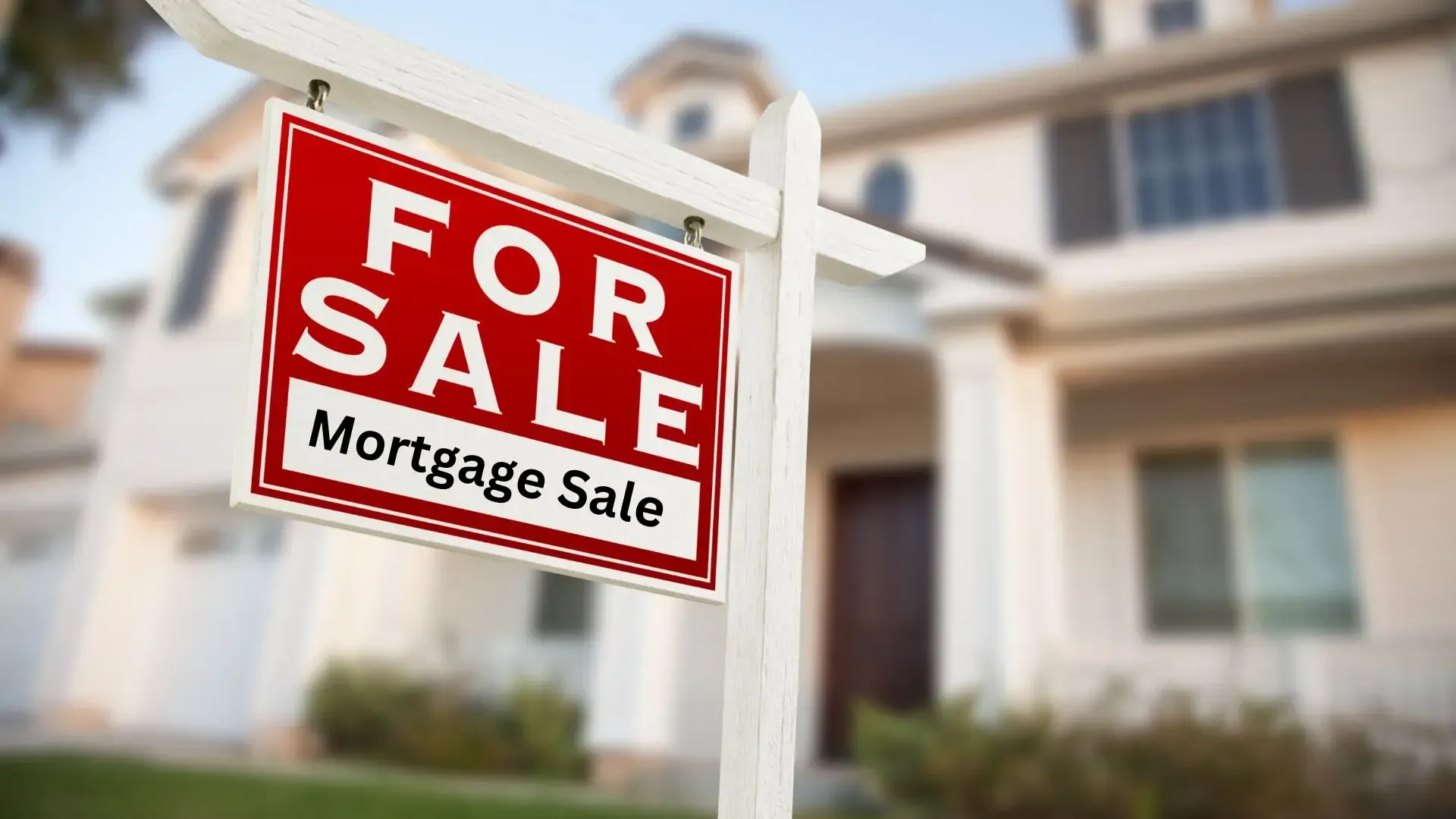 A for sale mortgage sale sign in front of a house.