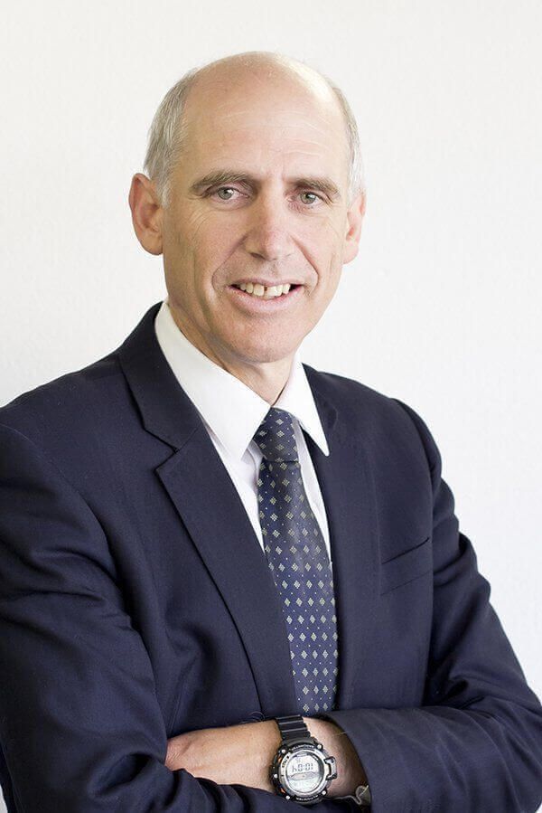 a man in a suit and tie with his arms crossed