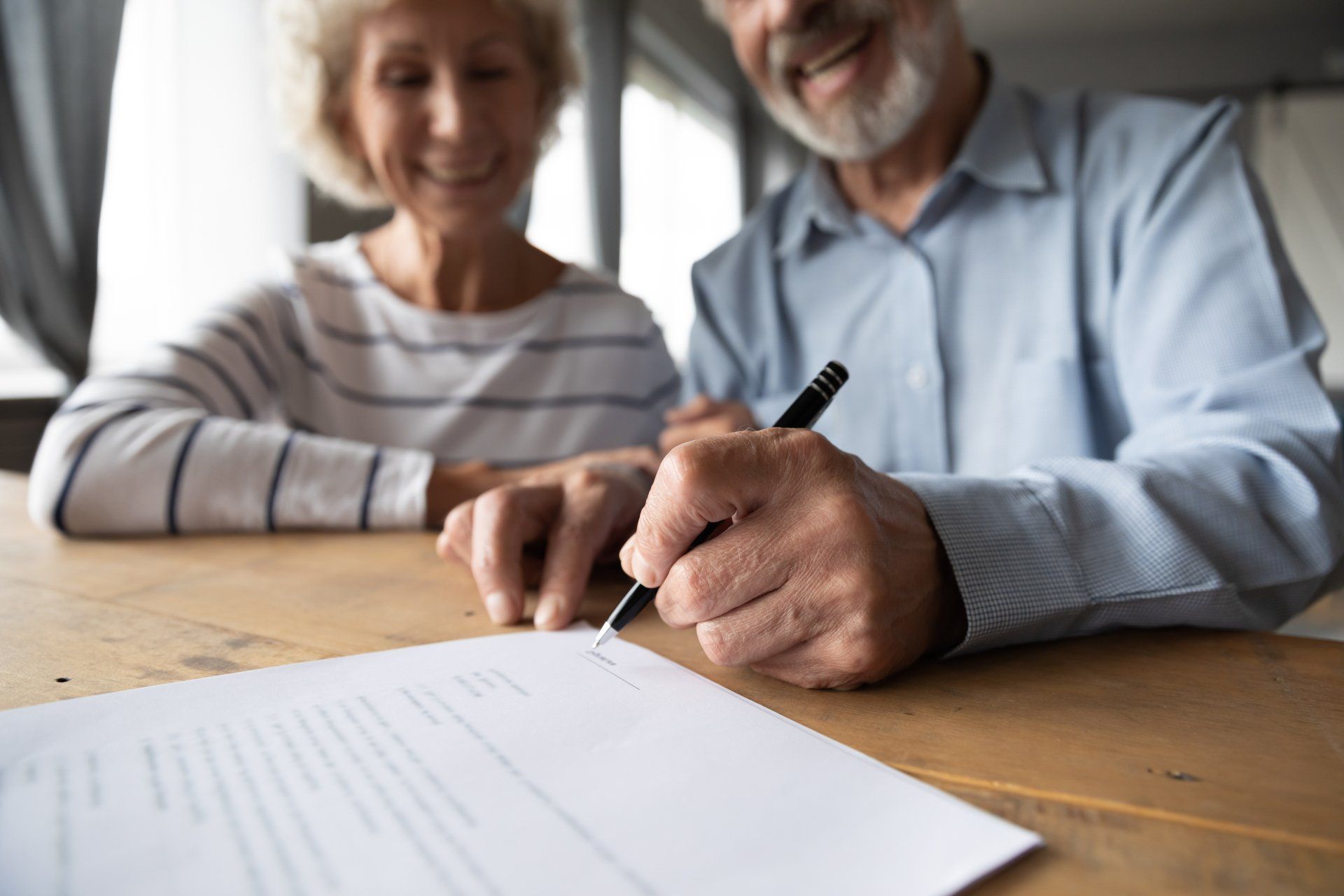 A more mature couple signing a Trust deed
