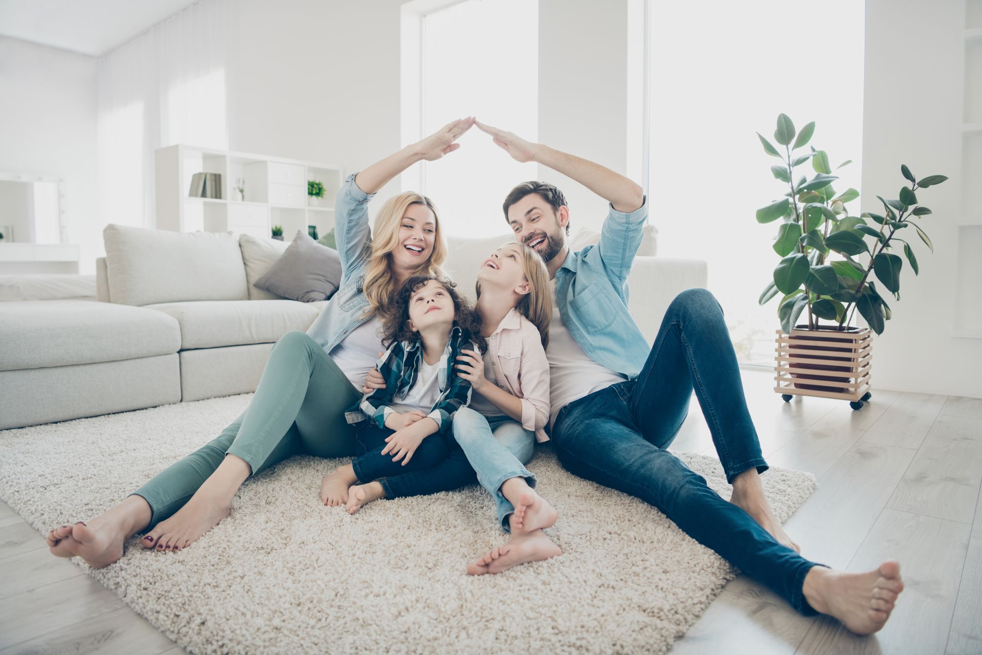 A Family Sitting On Top Of A Rug | WWL