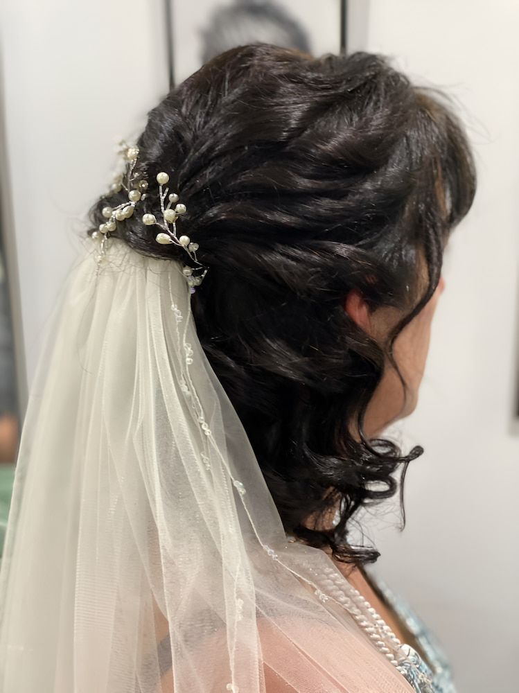A Woman Wearing A Veil And A Flower In Her Hair — Sarina Hair Fashions in Sarina, QLD
